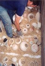 Pit Firing: Loading pots into the pit.