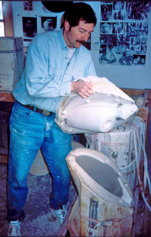 Robert taking apart mold after casting a form.