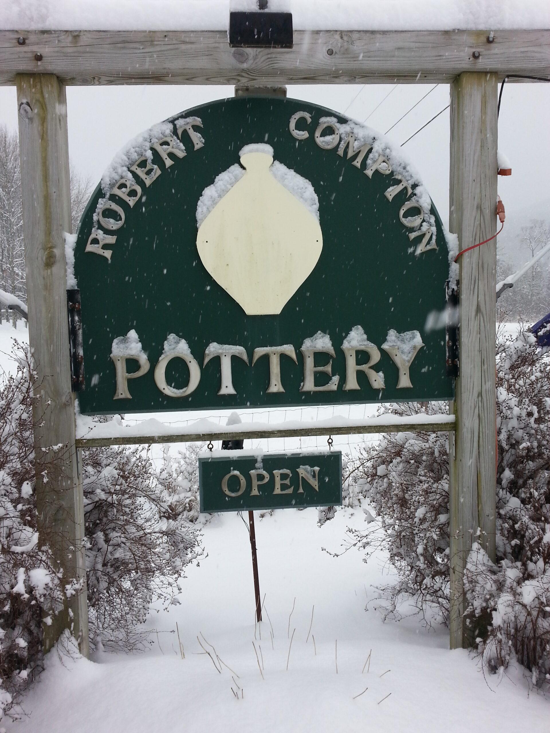 Our roadside pottery sign dusted with snow.